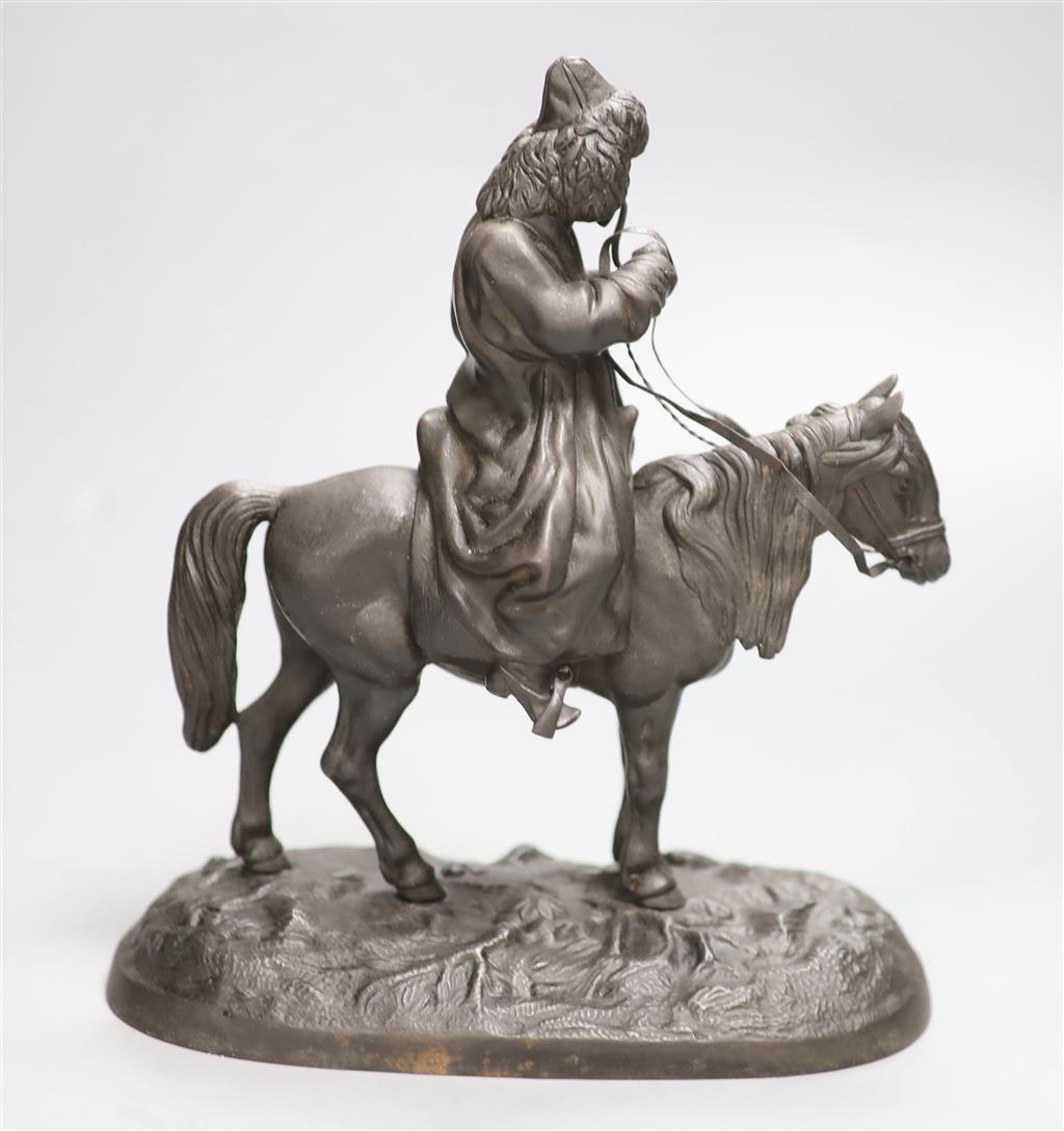 A late 19th century Russian cast iron group of a cossack on horseback